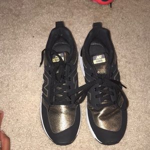 Gold and black new balances